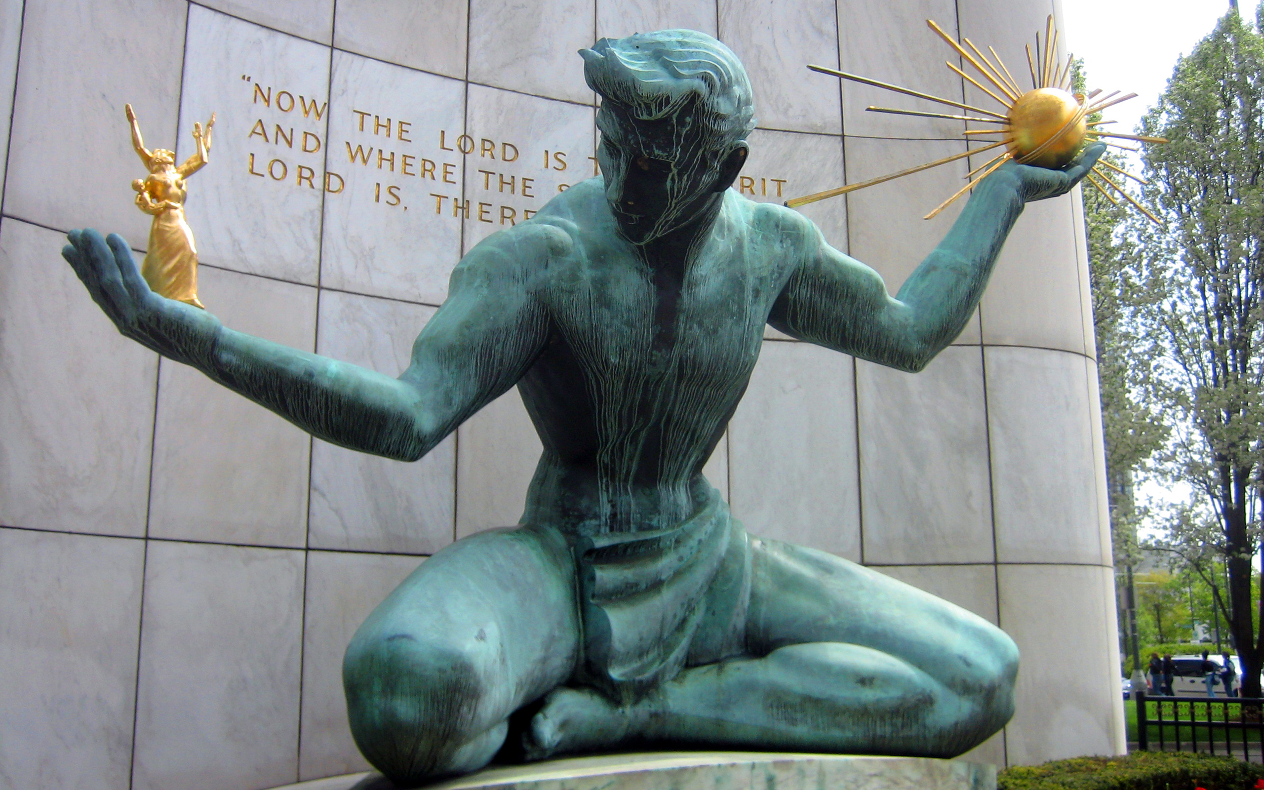 The Spirit of Detroit statue with its green patina and golden figures
